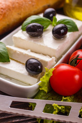 A piece of feta cheese on a wooden rustic background