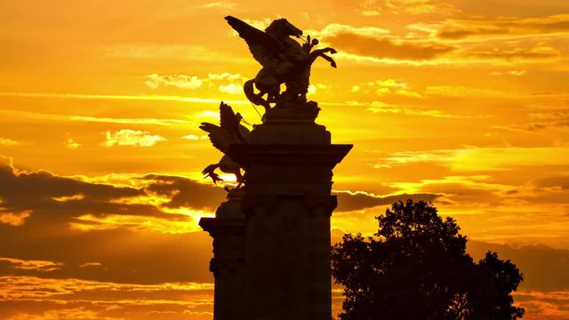 Time Lapse of a beautiful sunrise in Paris. The sun rises behind one of the many monuments in Paris.