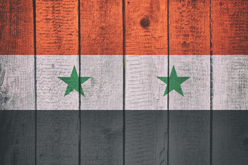 Flag of Syria on a Wooden Background. Syrian National Flags on a wood texture.