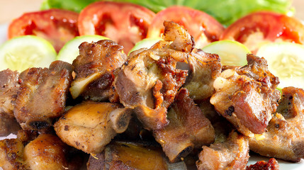 Fried deep pork ribs in white dish with vegetable thai food