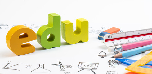 Wooden toy EDU on notebook with drawing doodle for education. Education and school background for STEM learning knowledge on white background.