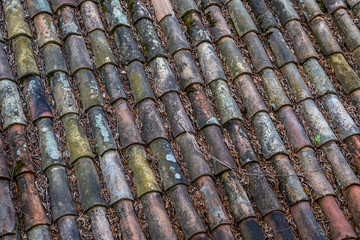 An old roof with burnt tiles, structure and background