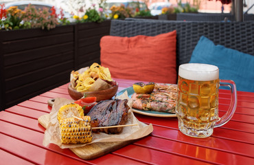 Beer and savory food on table