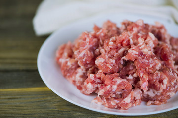 raw fresh minced pork on a white plate
