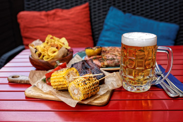 Grilled corn and smoked pork ribs with beer