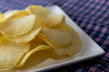 Close up potato chips on white dish