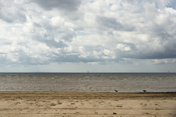 sand, water, clouds in midday in north