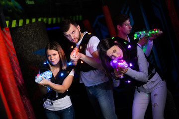 Young people playing laser tag