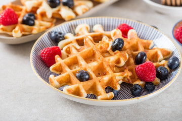Traditional homemade belgian waffles with fresh berries and syru