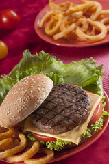 Beef Burger with bell pepper and lettuce with cherry red and yellow tomato on Red background 