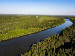 Fototapeta na wymiar Ob river flows through the taiga. River landscape, beautiful sky reflection in water. Vasyugan Swamp from aerial view. Tomsk region, Siberia, Russia