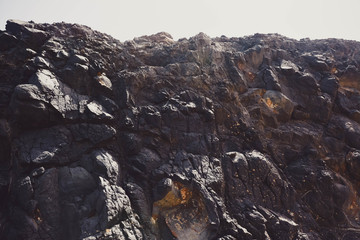Texture of the rocks in the mountains in Volcanic Island. Photo with added film and grain filter