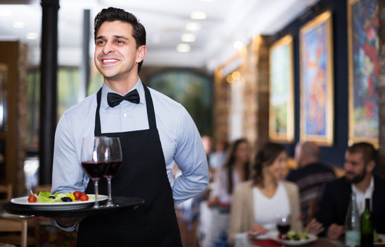 Waiter posing in restaurant