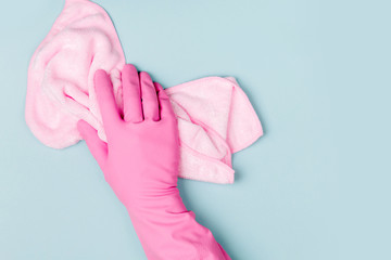 Female hands cleaning on blue background. Cleaning or housekeeping concept background. Copy space.  Flat lay, Top view.