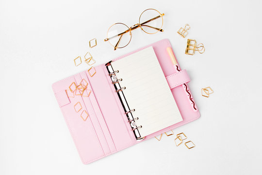 Pink planner with Business Stationery concept. Flat lay, top view