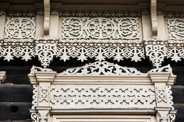 Carved wooden trim facade. Old historic house. Russian architecture. Chopped house with carved wooden architraves. Tomsk, Russia