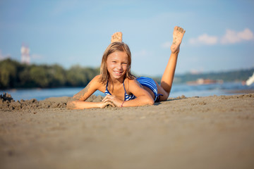 Adorable little girl at beach during summer vacation