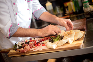 Obraz na płótnie Canvas Restaurant hotel private chef preparing making canapes starters