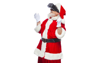 Christmas. Santa Claus in black virtual reality glasses makes gestures with his hands. Surprise, emotion. New technology. Isolated on white background.