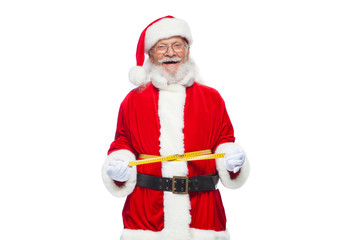 Christmas. Santa Claus is measuring waist with a tape. The concept of weight loss, healthy eating....