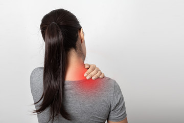 Woman with shoulder pain on white background