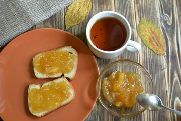 toast with apple jam tea cup on the table