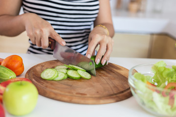 Healthy food Asian woman is cooking salad in kitchen, female preparing the vegetables and fruit at her house