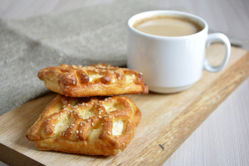 a cup of coffee with milk and baked 