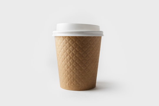 Blank kraft paper coffee cup with cap. Disposable cup.