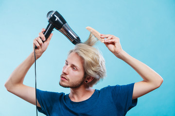 Trendy man with hair dryer