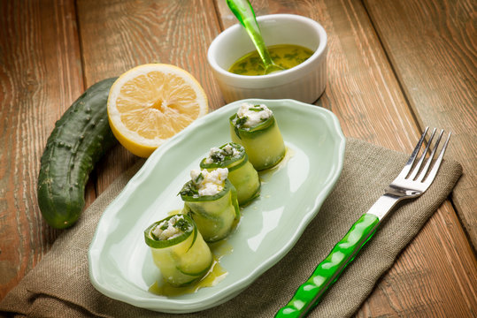 filled sliced cucumber with fresh cheese and lemon and oil sauce