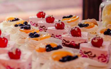 Sweets, colorful cupcakes with fruit on a tray