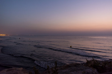 Sea waves with buoys and horizon in early morning at dawn