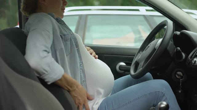 Pregnant female sitting in auto and feeling pain in stomach, risk of misbirth