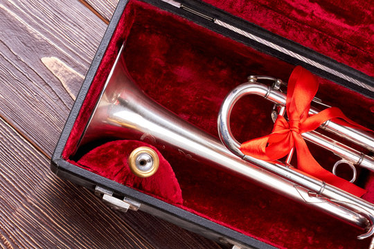 Christmas silver trumpet in box. Brass trumpet in velvet case. Traditional musical instrument.