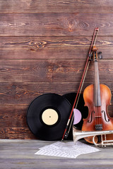 Set of musical instruments and copy space. Vinyl records, violin, trumpet and sheets of musical...