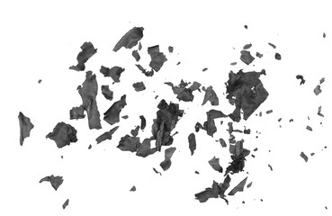 Obraz premium Burned, charred paper scraps isolated on white background, top view