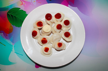 Dumplings in a plate decorated with ketchup