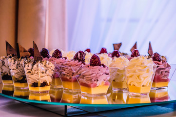 Sweets, colorful cupcakes with fruit on a tray