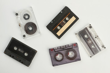 Set of different audio cassette tapes. Five audio tapes on light background. Old-fashioned music devices.