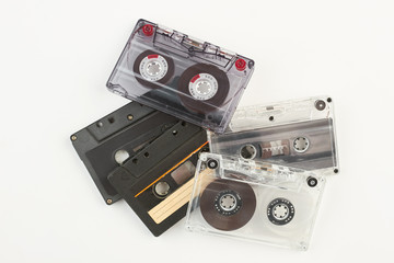 Pile of retro cassette tapes. Stack of old tape cassetes over white background. Music vintage...