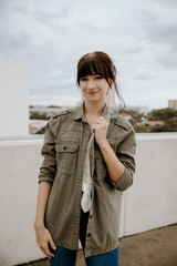 Obraz premium Cute Trendy Young Female Model Posing on Top Floor of Parking Garage