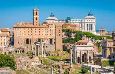 Fototapeta na wymiar Scenic sight in the Roman Forum, with the Campidoglio Hill, the Vittoriano monument and the Settimio Severo Arch.