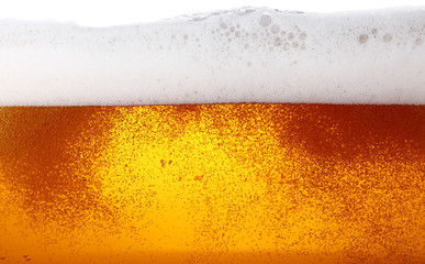Close up background of beer with bubbles in glass