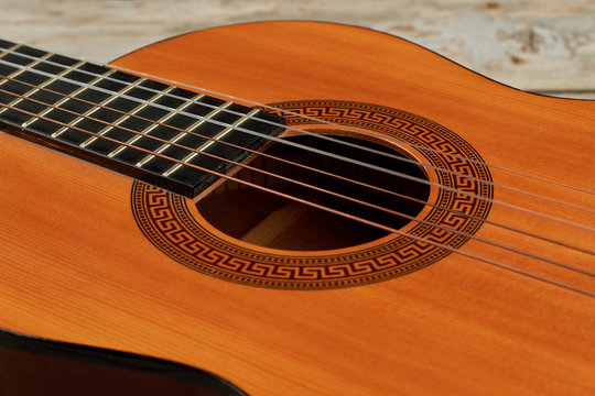 Acoustic guitar close up. Six strings of classical acoustic guitar. Popular musical instrument.