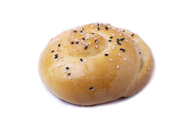 Yeast dough bun sprinkled with sesame seeds isolated on white
