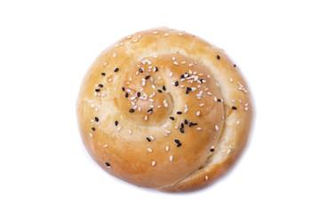 Yeast dough bun sprinkled with sesame seeds isolated on white