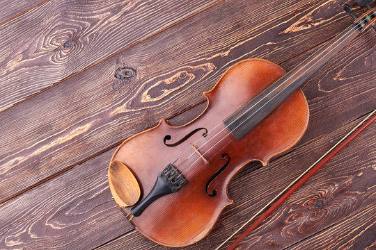 Stringed instrument of orchestra. Vintage violin, bow and copy space. Classical instrument of symphony orchestra.
