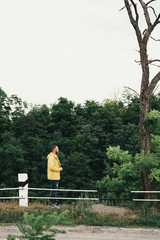 a man in a yellow raincoat with a camera