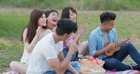 Youngster friends having fun in the picnic time at the park